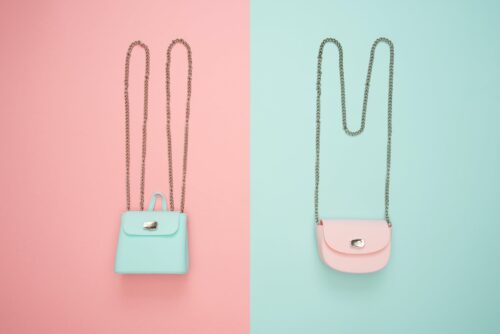 photo of two teal and pink leather crossbody bags